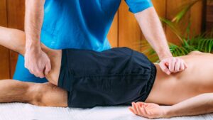 Pain Relief Manual Massage Treatment. Physical Therapist Massaging Lower Back.