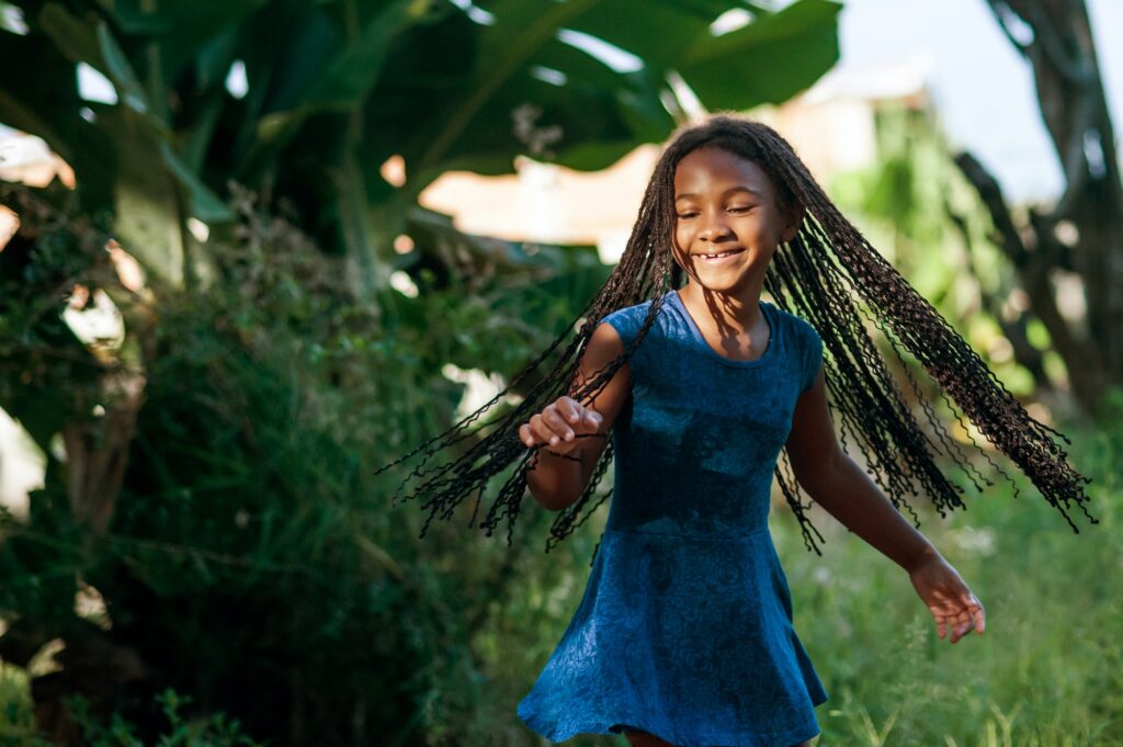 African girl playing and dancing in the nature